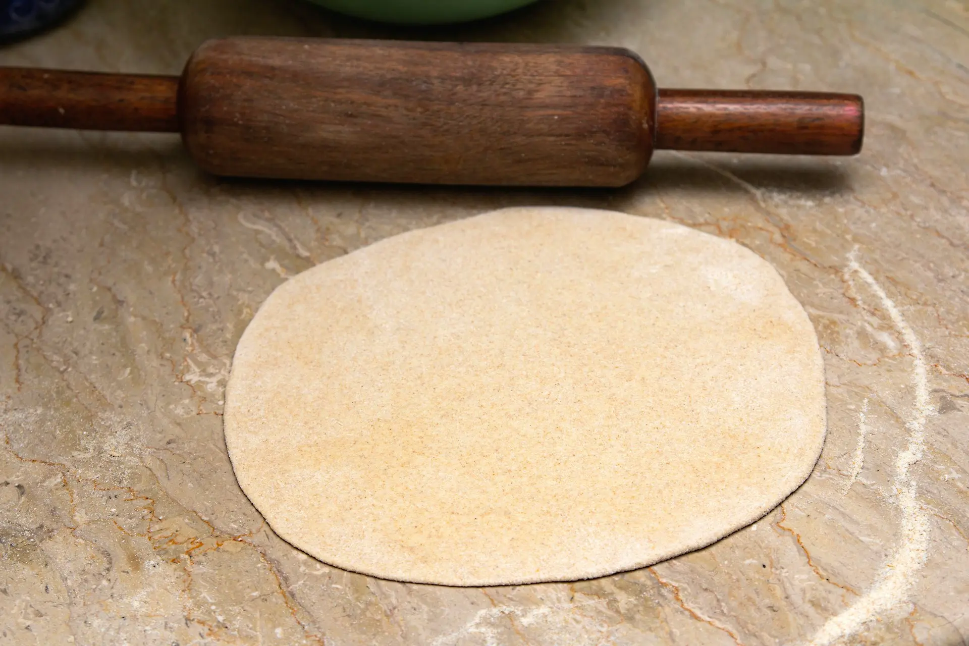 brown wooden rolling pin on brown wooden table
